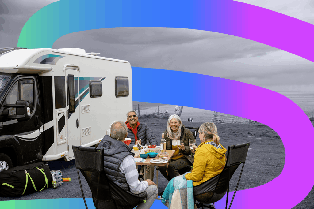 Friends enjoying lunch by the coast whilst on a motorhome holiday